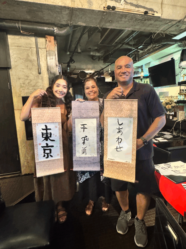 alt="Guest painting kanji scroll – calligraphy experience Tokyo