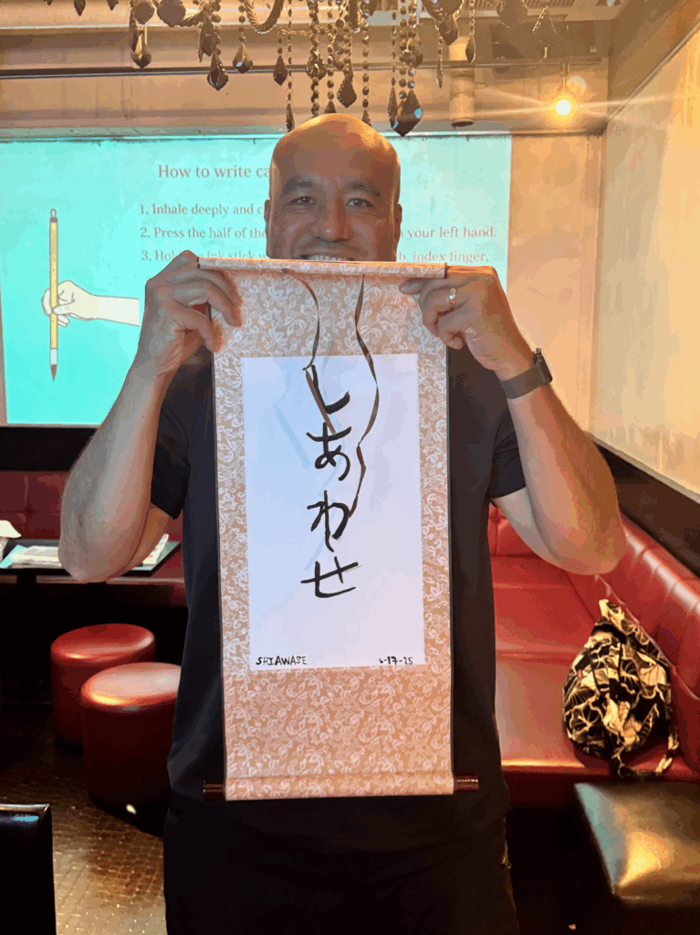 Family painting ‘東京’ scroll at Shodocafe7557 calligraphy experience in Roppongi, Tokyo.