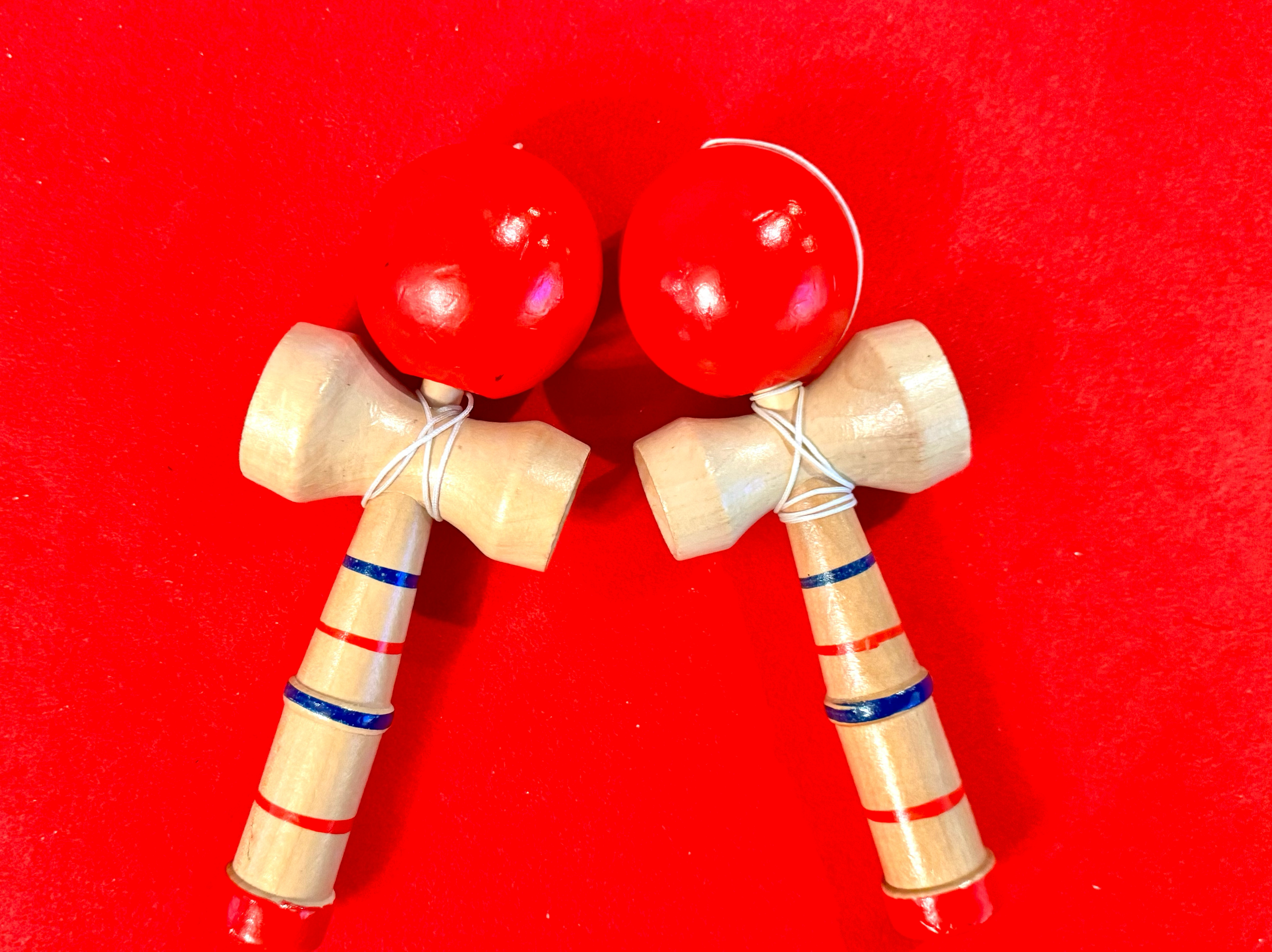 shodocafe7557 kendama lesson Two kendama toys on red cloth at Shodocafe7557 in Roppongi, Tokyo – book a Kendama lesson with our calligraphy experience.