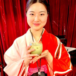 Smiling staff member Moe in kimono with matcha latte at Shodocafe7557, Tokyo