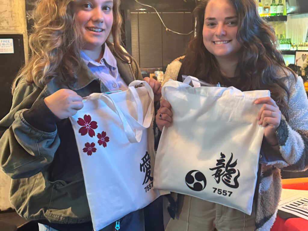 two female friends smiling with kanji tote bags edited Friends Showing “Love” & “Dragon” Kanji Totes – Shodocafe 7557