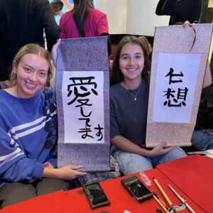 School trip students enjoying a group calligraphy experience at Shodocafe7557 in Roppongi, Tokyo