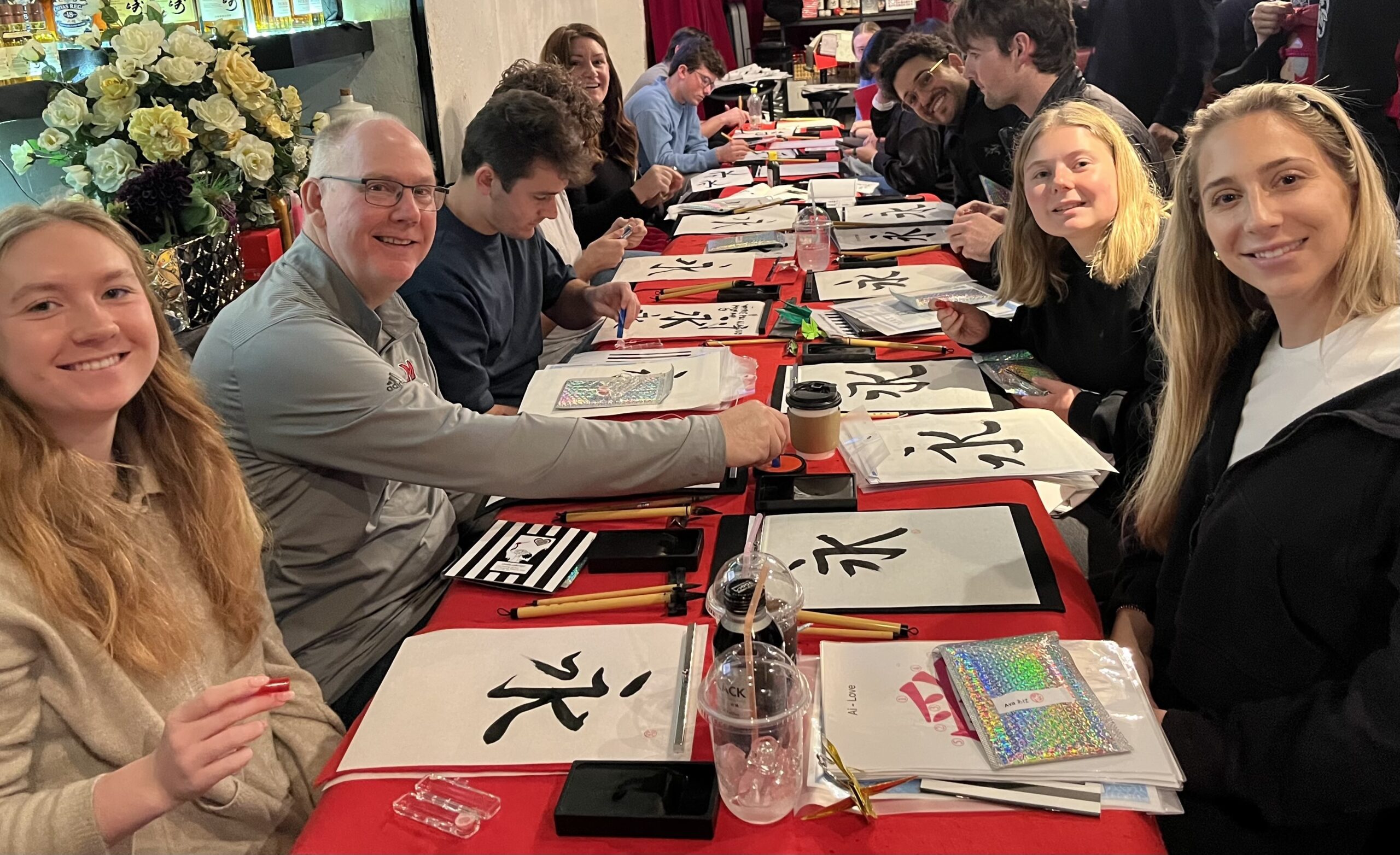 School trip group enjoying a Japanese calligraphy experience at Shodocafe7557 in Roppongi, Tokyo