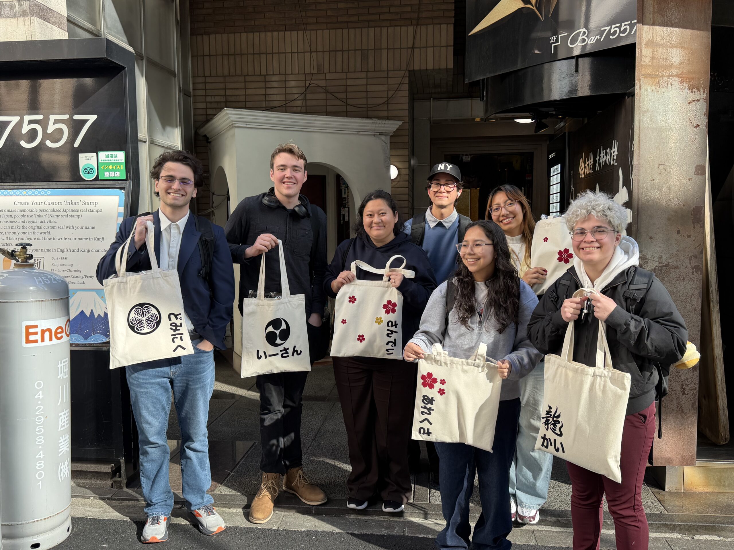 group hiragana tote bag calligraphy experience tokyo shodocafe7557 scaled Group of students holding hiragana name tote bags after a calligraphy experience in Tokyo at Shodocafe7557